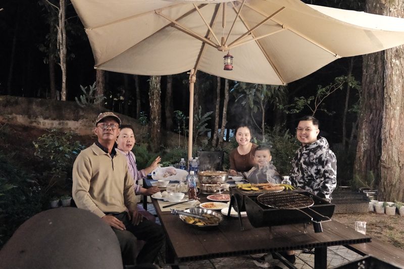 Nhóm bạn quây quần bên bàn BBQ dưới dù tại GIA AN